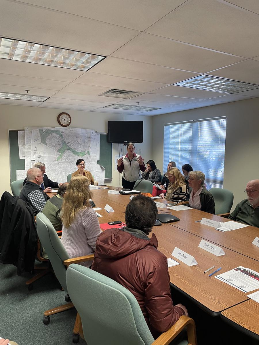 A group of people sitting at a table discussing the USDA’s Specialty Crops Competitiveness Initiative.